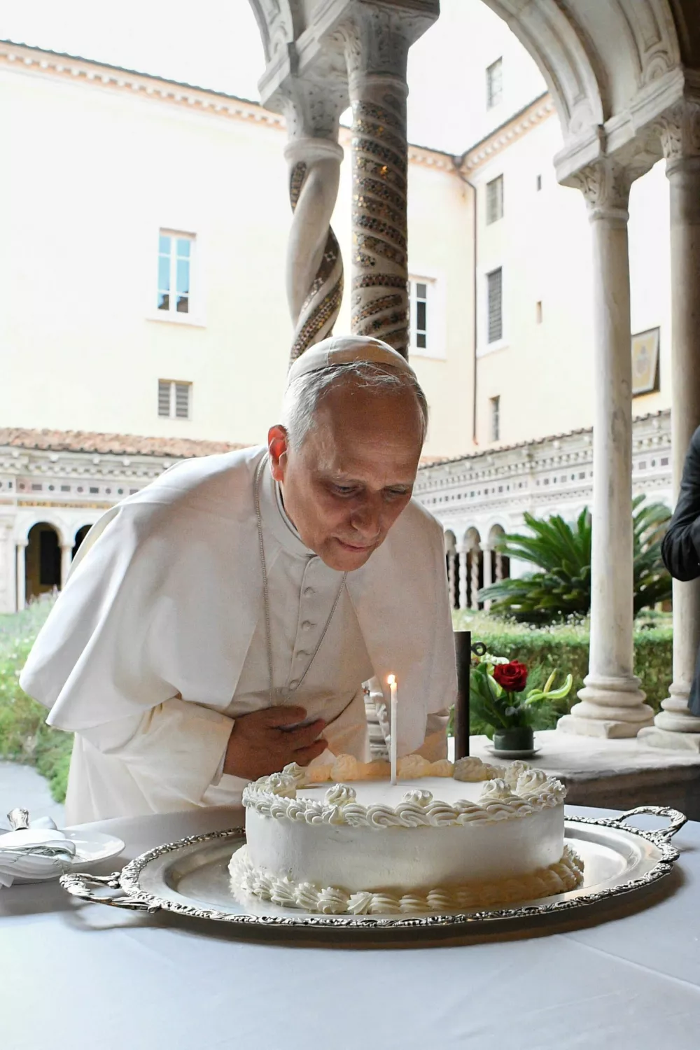 Pope Leo blows a candle as he marks his 70th birthday with with cardinals, Christian representatives and dignitaries after a commemoration for the Martyrs and Witnesses of Faith of the 21st century at the Basilica of St. Paul in Rome, Italy September 14, 2025. Vatican Media/­Handout via REUTERS  ATTENTION EDITORS - THIS IMAGE WAS PROVIDED BY A THIRD PARTY.