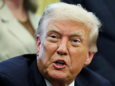 U.S. President Donald Trump reacts after signing a memorandum to send federal resources to Memphis, Tennessee, for a surge against local crime, in the Oval Office at the White House in Washington, D.C., U.S., September 15, 2025. REUTERS/Jonathan Ernst