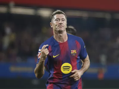 Barcelona's Robert Lewandowski celebrates scoring his side's 5th goal during a Spanish La Liga soccer match between FC Barcelona and Valencia at the Johan Cruyff stadium in Barcelona, Spain, Sunday, Sept. 14, 2025. (AP Photo/Joan Monfort)