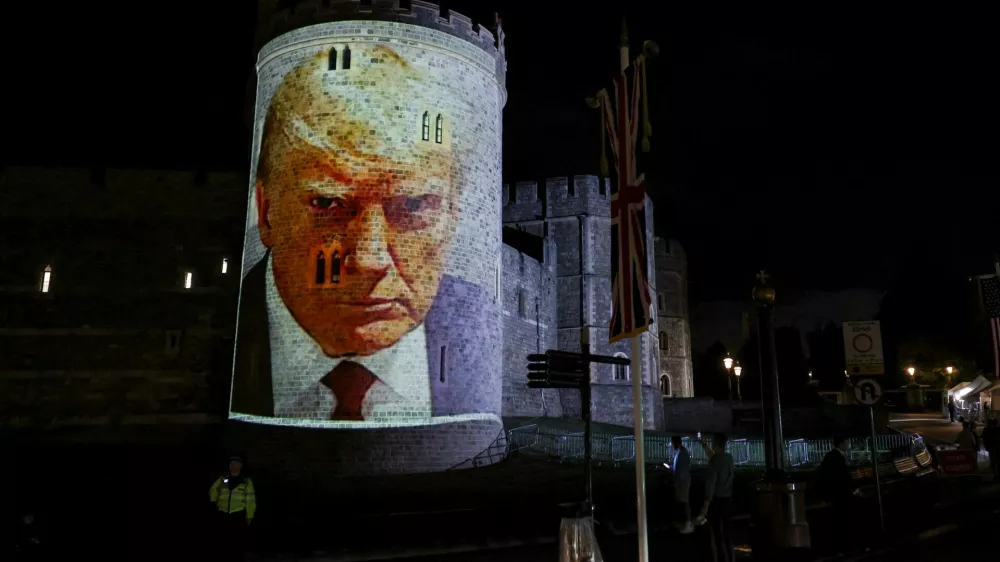 U.S. President Donald Trump's mugshot is projected on Windsor castle, after U.S. President Donald Trump and first lady Melania Trump arrival for a state visit to the country, in Windsor, Berkshire, Britain September 16, 2025. REUTERS/Phil Noble