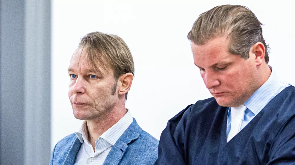 A man, who is a suspect in the disappearance of British toddler Madeleine McCann in Portugal, stands next to his lawyer Friedrich Fuelscher at his trial on unrelated sexual assault charges in Braunschweig, Germany, October 2, 2024. Christian B., is charged with three counts of aggravated rape and two counts of sexual abuse of children in Portugal between June 2007 and December 2000.   Moritz Frankenberg/Pool via REUTERS