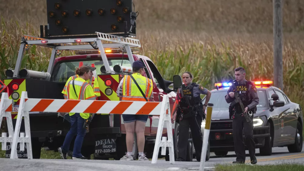 Pennsylvania state police troopers and emergency workers block a road after multiple police officers were shot and killed on Wednesday, Sept. 17, 2025, in North Codorus, Pa. (AP Photo/Matt Slocum)
