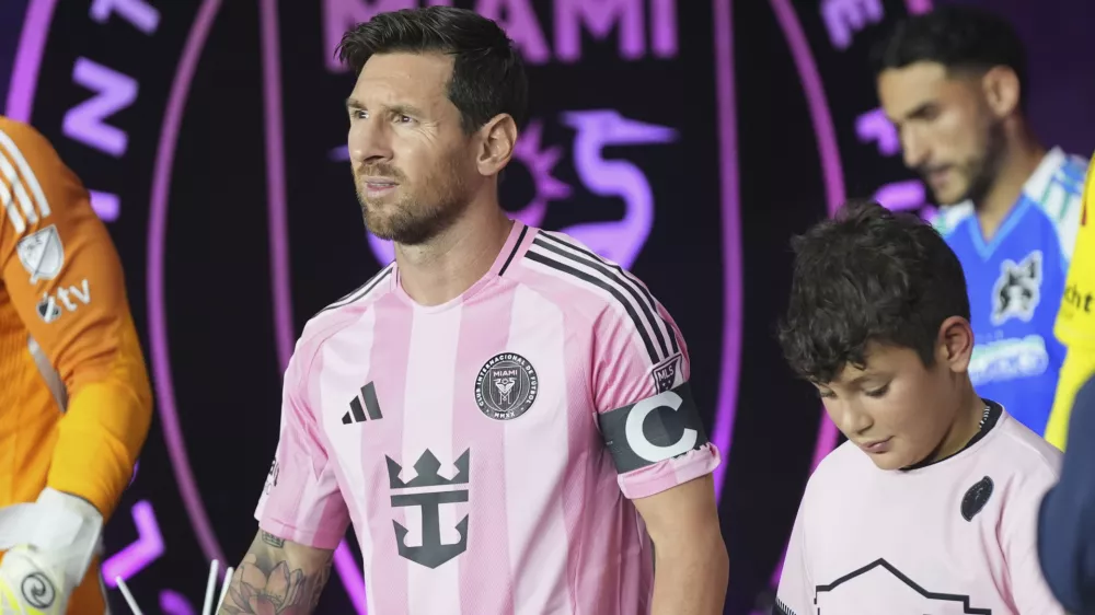 Inter Miami forward Lionel Messi, left, walks onto the field before an MLS soccer match against the Seattle Sounders, Tuesday, Sept. 16, 2025, in Fort Lauderdale, Fla. (AP Photo/Lynne Sladky)