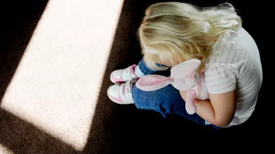 DHF9WT A small girl holding a bunny rabbit in silhouette picture posed by model abuse, child abuse, neglect, child grooming