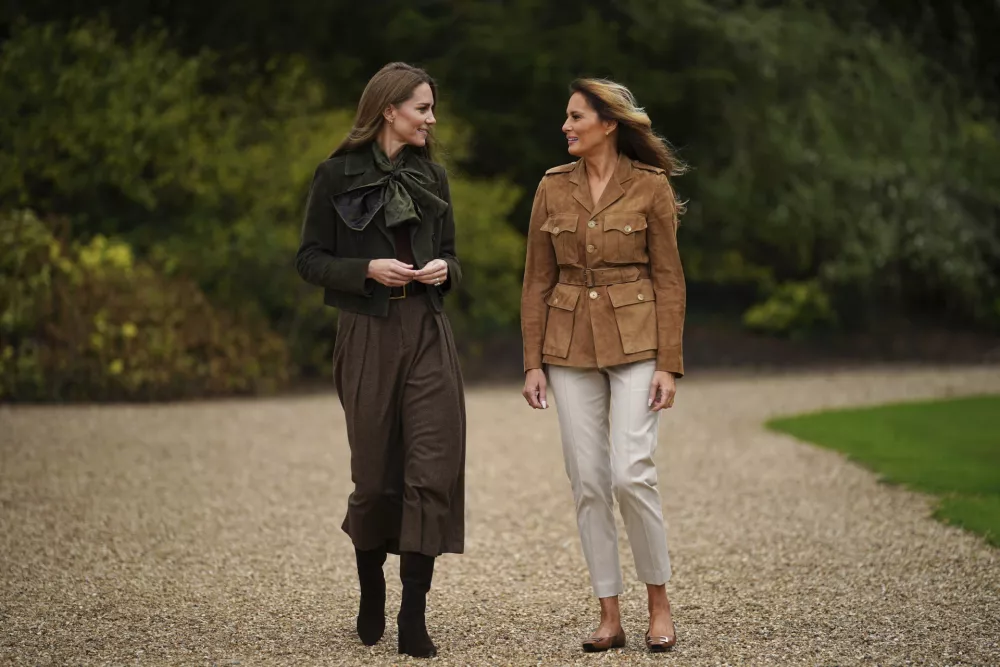 Britain's Kate, Princess of Wales, left, and first lady Melania Trump walk in Frogmore Gardens, Windsor, England, Thursday, Sept. 18, 2025. (Yui Mok/Pool Photo via AP)