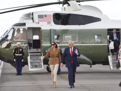 President Donald Trump and first lady Melania Trump wave after arriving on Marine One at Stansted Airport, Thursday, Sept. 18, 2025, in Stansted, England. (AP Photo/Evan Vucci)