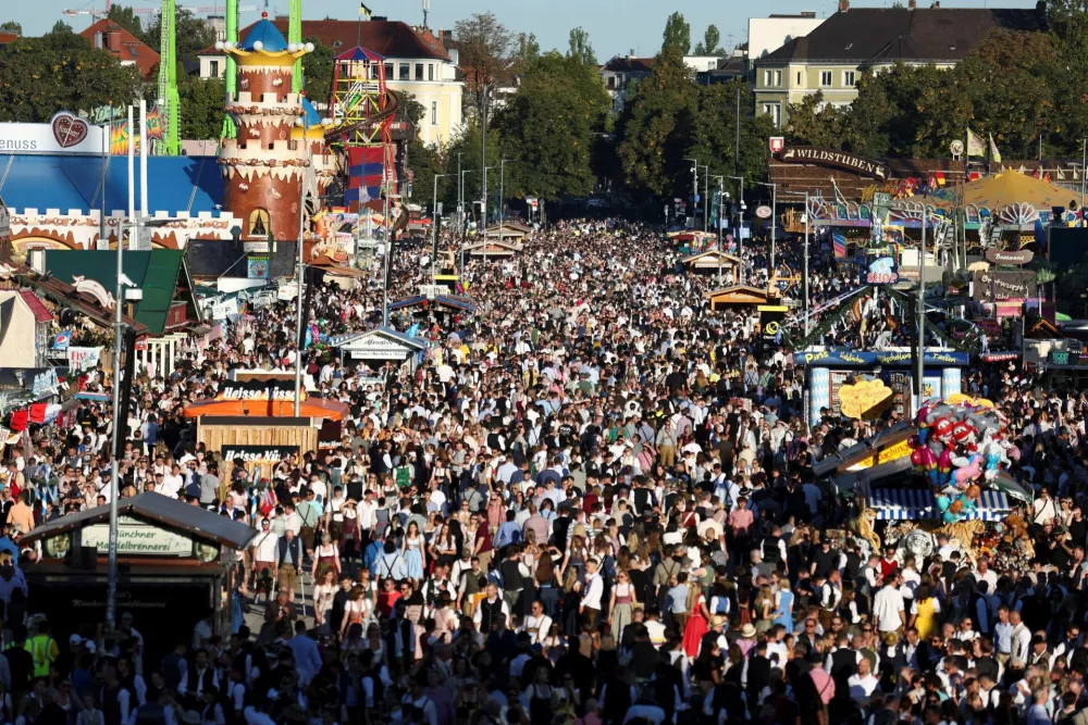 People visit Theresienwiese on the day of the official opening of the 190th Oktoberfest, the world's largest beer festival in Munich, Germany, September 20, 2025. REUTERS/Maryam Majd