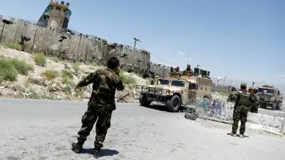 FILE PHOTO: Afghan soldiers stand guard at a checkpoint outside the U.S Bagram air base, on the day the last of American troops vacated it, Parwan province, Afghanistan July 2, 2021.REUTERS/Mohammad Ismail/File Photo