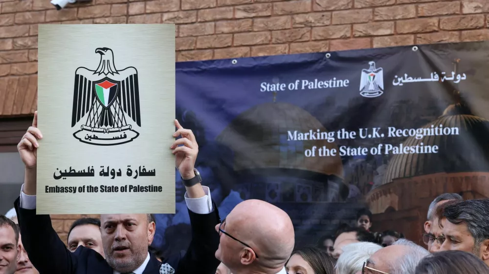 Husam Zomlot, head of the Palestinian mission to the United Kingdom, holds up a plaque which reads "Embassy of the State of Palestine" during a ceremony after the British government announced on Sunday the country's formal recognition of a Palestinian state, at the mission's headquarters in London, Britain, September 22, 2025. REUTERS/Toby Melville    TPX IMAGES OF THE DAY