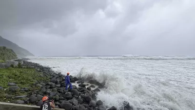 People watch as strong waves batter Basco, Batanes province, northern Philippines as Typhoon Ragasa affects the area on Monday, Sept. 22, 2025. (AP Photo/Justine Mark Pillie Fajardo)