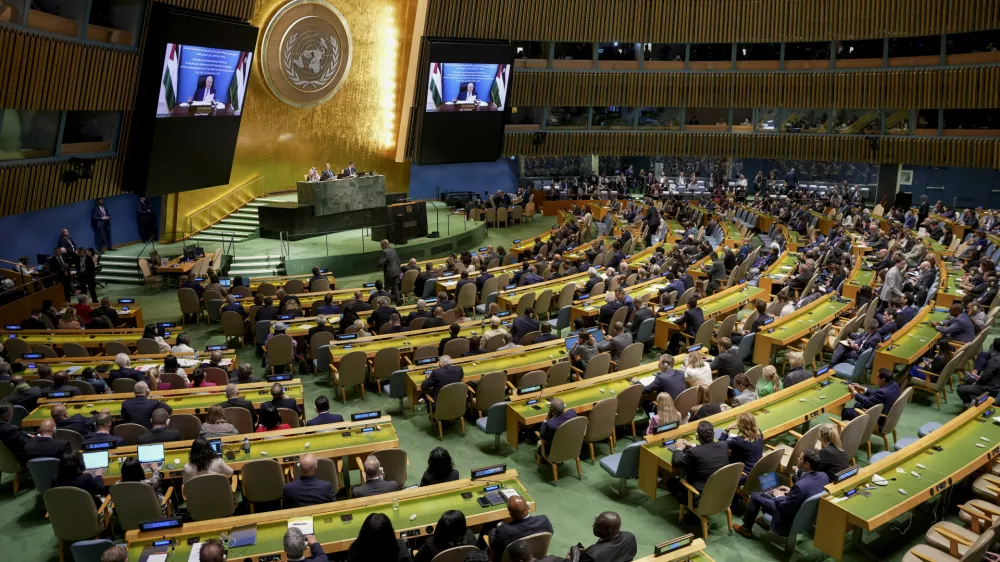 Palestinian President Mahmoud Abbas appears on a screen as he speaks virtually during a high-profile meeting at the United Nations aimed at galvanizing support for a two-state solution to the Israeli-Palestinian conflict Monday, Sept. 22, 2025, at UN headquarters. (AP Photo/Angelina Katsanis)