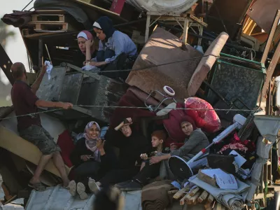 Displaced Palestinians flee northern Gaza Strip, by foot and in vehicles, carrying their belongings along the coastal road, near Wadi Gaza, Tuesday, Sept. 23, 2025. (AP Photo/Abdel Kareem Hana)