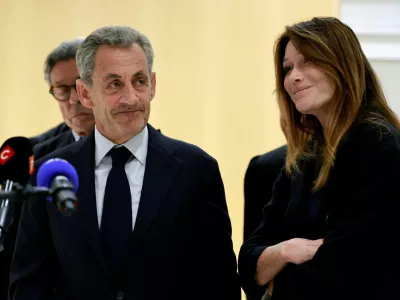 Former French President Nicolas Sarkozy reacts as he talks to journalists, next to his wife Carla-Bruni Sarkozy and his lawyers, after the verdict in his trial with other defendants on charges of corruption and illegal financing of an election campaign related to alleged Libyan funding of his successful 2007 presidential bid, at the courthouse in Paris, France, September 25, 2025. REUTERS/Stephanie Lecocq