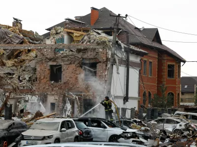 An emergency responder works at an impact site in a residential neighbourhood after Russian drone and missile attacks in Kyiv, Ukraine, September 28, 2025. REUTERS/Thomas Peter