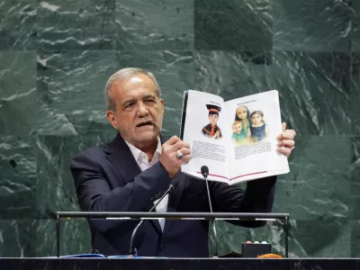 FILE PHOTO: Iran's President Masoud Pezeshkian shows pages of a book as he addresses the 80th United Nations General Assembly (UNGA) at the U.N. headquarters in New York, U.S., September 24, 2025. REUTERS/Jeenah Moon/File Photo