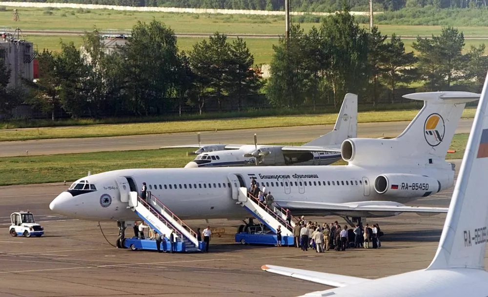 People board a Tupolev 154 plane of Bashkirian Airlines at Moscow's Domodedovo airport on Tuesday, July 2, 2002. A similar Tupolev 154 charter filled with children and a Boeing 757 DHL cargo plane collided over southern Germany late Monday, July 1, 2002. All aboard both planes are believed to have been killed after the collision at about 36,000 feet. The crash prompted an angry clash between Russian aviation authorities and Swiss air traffic controllers. (AP Photo/ Misha Japaridze)