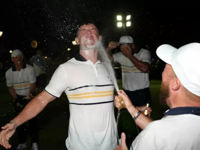 Golf - The 2025 Ryder Cup - Bethpage Black Golf Course, Farmingdale, New York, United States - September 28, 2025 Team Europe's Shane Lowry and Rory McIlroy spray champagne as they celebrate winning the Ryder Cup REUTERS/Paul Childs