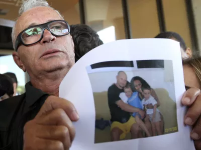 Nelson Marinho holds a photo of his son Nelson Marinho, seen with his family, a passenger on Air France flight 447 that was reported missing on its way from Rio de Janeiro to Paris, at the Windsor hotel in Rio de Janeiro, Wednesday, June 3, 2009. Brazil's military found a 3-mile (5-kilometer) path of wreckage in the Atlantic Ocean, confirming that the jet carrying 228 people crashed in the sea, according to Defense Minister Nelson Jobim. (AP Photo/Patricia Santos)