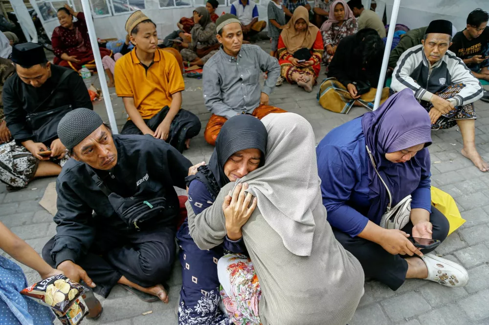 A relative of a victim of a collapsed building reacts, after a hall collapsed while students were praying at the Al-Khoziny Islamic boarding school in Sidoarjo, East Java, Indonesia, September 30, 2025. REUTERS/Dipta Wahyu   TPX IMAGES OF THE DAY