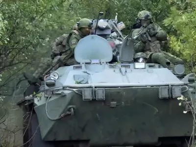 In this photo taken from video released by Russian Defense Ministry Press Service on Monday, Sept. 29, 2025, Russian soldiers ride an APC on an undisclosed location in Ukraine. (Russian Defense Ministry Press Service via AP)