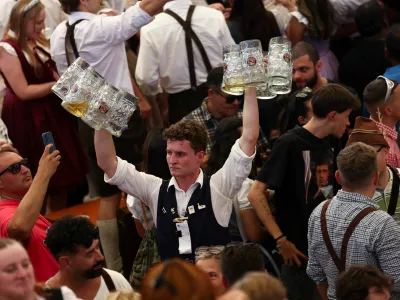 A man carries beer mugs on the day of the official opening of the 190th Oktoberfest, the world's largest beer festival in Munich, Germany, September 20, 2025. REUTERS/Maryam Majd
