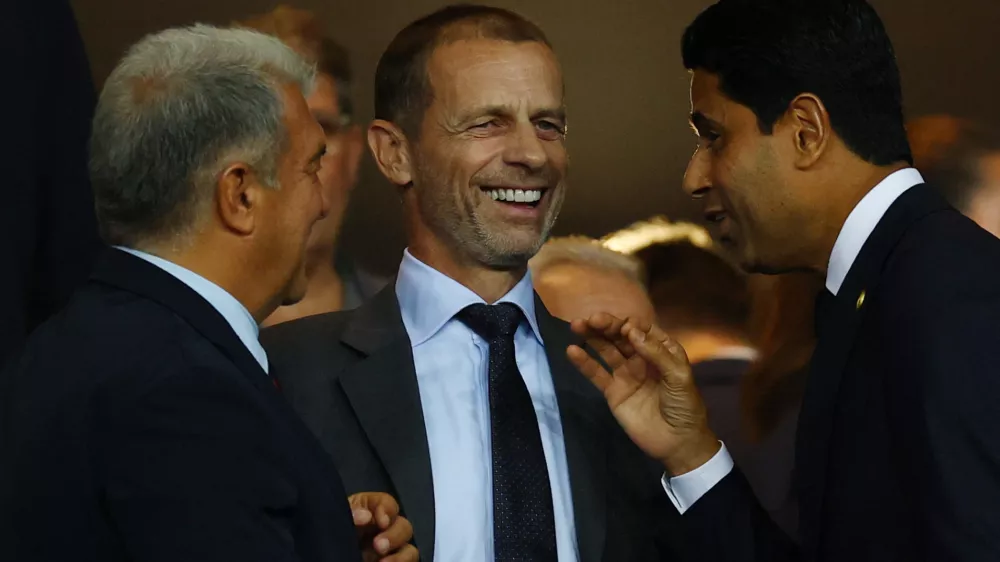 Soccer Football - UEFA Champions League - FC Barcelona v Paris St Germain - Estadi Olimpic Lluis Companys, Barcelona, Spain - October 1, 2025 FC Barcelona president Joan Laporta, UEFA president Aleksander Ceferin and Paris St Germain president Nasser Al-Khelaifi talk in the stands before the match REUTERS/Albert Gea