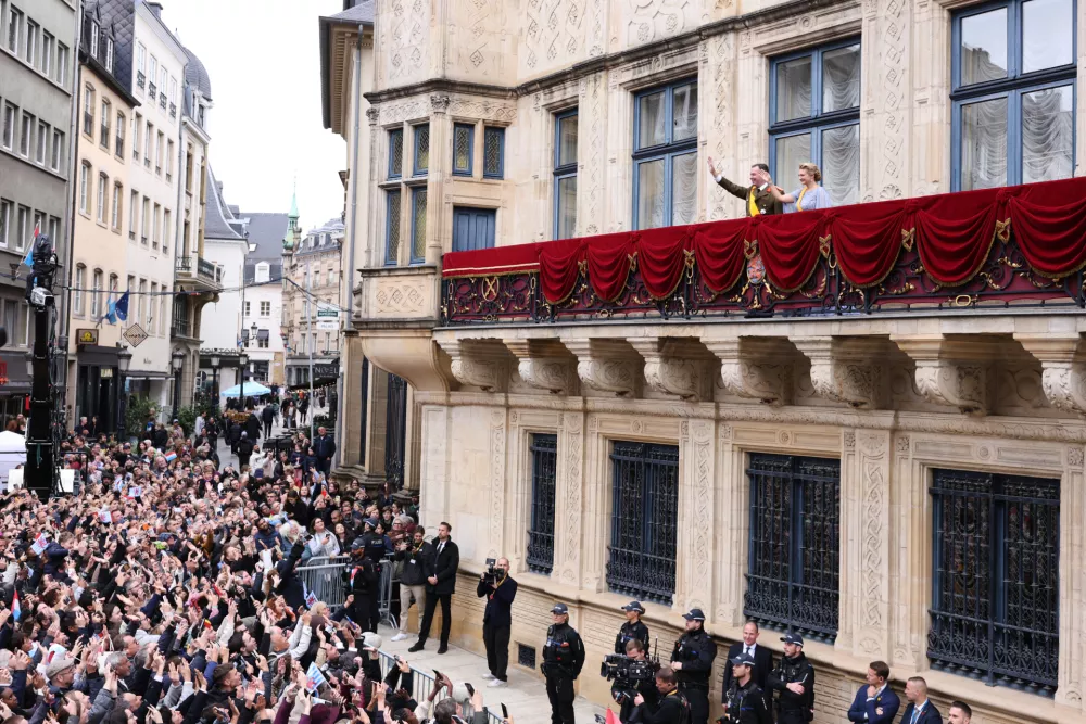 Luxembourg's Grand Duke Guillaume and Luxembourg's Grand Duchess Stephanie wave from the balcony of the Grand Ducal Palace in Luxembourg, Friday, Oct. 3, 2025. (AP Photo/Omar Havana)