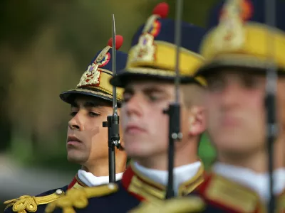 Romanian soldiers stand to attention during a ceremony to mark Romania's Army Day in Bucharest, October 25, 2005. Romania, which became a NATO member in 2004 along with neighbour Bulgaria, must modernise its armed forces and create a flexible, smaller and professional army up to the alliance's standards in the coming years Romanian Defence Minister Teodor Atanasiu said.  REUTERS/Bogdan Cristel