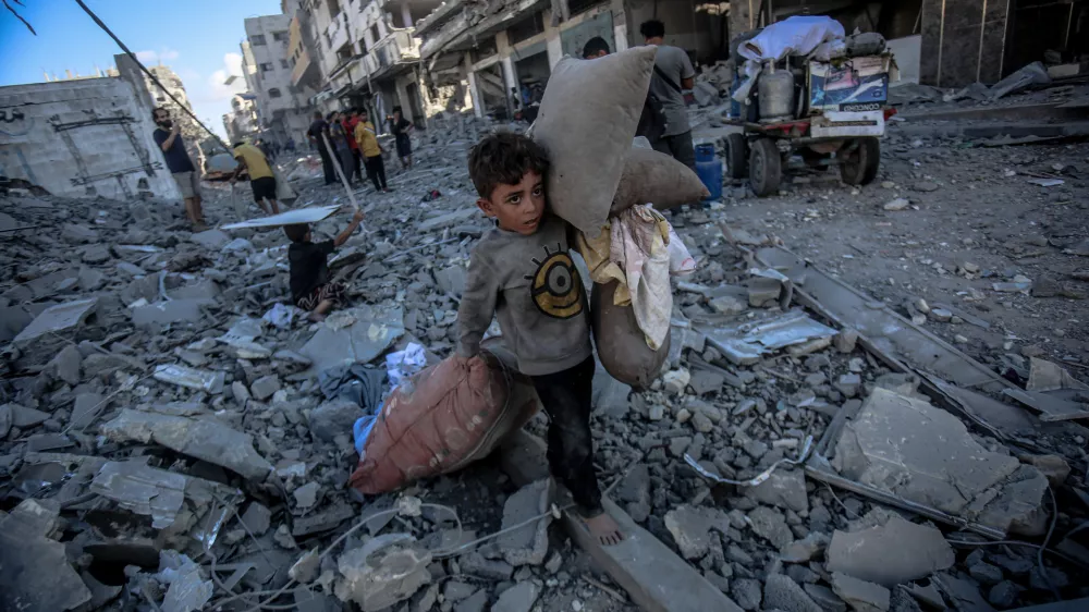 GAZA CITY, GAZA - SEPTEMBER 30: Palestinian children collect usable belongings from the rubble after the Israeli strike on Abu Hasira Street in Gaza City, Gaza, on September 30, 2025. Several buildings were completely destroyed, and many others were severely damaged in the strike. Saeed M. M. T. Jaras / AnadoluNo Use USA No use UK No use Canada No use France No use Japan No use Italy No use Australia No use Spain No use Belgium No use Korea No use South Africa No use Hong Kong No use New Zealand No use Turkey