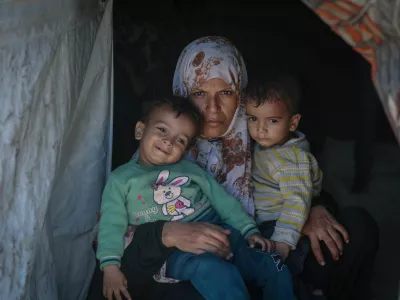 Displaced Palestinian mother Iman Abdel Halim Abu Mutlaq holds her twin sons Uday and Hamza Abu Odah at their tent where they shelter, in Mawasi area, in Khan Younis in the southern Gaza Strip, September 18, 2025. Uday and Hamza were born on 2 November 2023, less than four weeks after the Hamas attack that triggered Israel's devastating assault on Gaza that has defined and encompassed their brief lives. They have lost their home and lived in tents and on the street. Their father was killed seeking aid and two brothers were wounded. They have suffered constant hunger, frequent bouts of sickness and repeated episodes of terrifying bombardment. Their mother is frightened that the longer Israel's assault goes on, the more they - and the new generation of Gazans - will be scarred. "We are afraid this war will never stop, that it has a beginning and no end," she said. REUTERS/Ramadan Abed SEARCH "GAZA TWINS ODAH" FOR THIS STORY. SEARCH "WIDER IMAGE" FOR ALL STORIES. TPX IMAGES OF THE DAY