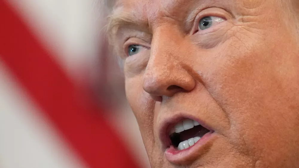 President Donald Trump speaks to reporters before signing an executive order in the Oval Office at the White House, Monday, Oct. 6, 2025, in Washington. (AP Photo/Jacquelyn Martin)