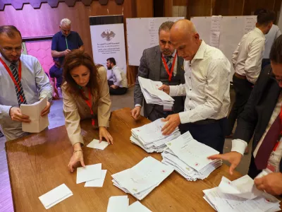 Officials count the votes of electoral college members in a parliamentary election at a polling station in Aleppo, Syria, Sunday, Oct. 5, 2025. (AP Photo/Omar Albam)