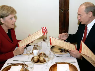Russian President Vladimir Putin (R) and German Chancellor Angela Merkel talk before lunch at a restaurant in Russia's Siberian city of Tomsk April 27, 2006. Russia hopes to pay off its remaining Paris Club debt completely this year, President Vladimir Putin said on Thursday, although it was not clear from Putin's remarks how it would happen. EDITORIAL USE ONLY  REUTERS/ITAR-TASS/PRESIDENTIAL PRESS SERVICE