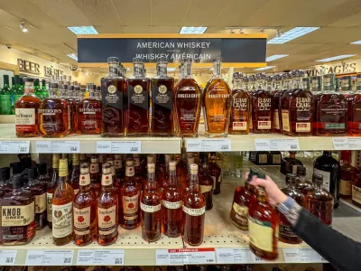 FILE PHOTO: A worker places bottles of American whiskey into a shopping cart to fill an order for a restaurant, at a Liquor Control Board of Ontario (LCBO) store in Hamilton, Ontario, Canada February 2, 2025. REUTERS/Carlos Osorio/File Photo