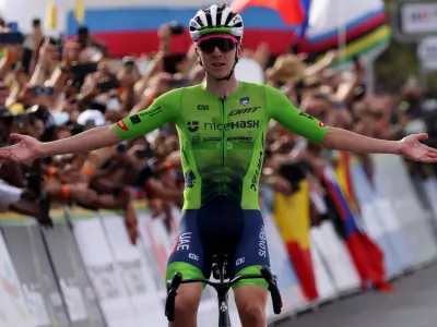 Cycling - Road World Championships 2025 - Kigali, Rwanda - September 28, 2025 Slovenia's Tadej Pogacar celebrates as he crosses the finish line to win the Men's Elite Road Race REUTERS/Jean Bizimana