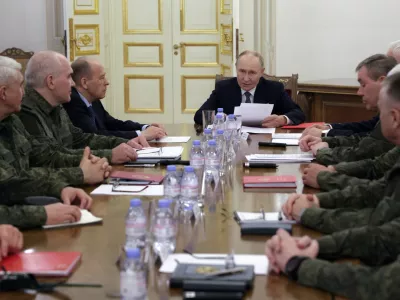 Russian President Vladimir Putin, center, speaks to the leadership of the Russian Ministry of Defense and the General Staff, commanders of troop groups in the special military operation zone in St. Petersburg, Russia, Tuesday, Oct. 7, 2025. (Mikhail Metzel, Sputnik, Kremlin Pool Photo via AP)
