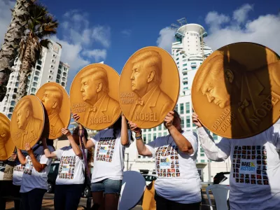 Protesters hold up signs with images depicting U.S. President Donald Trump and the words "Nobel" written on them, as supporters and family members of hostages who were kidnapped during the deadly October 7, 2023 attack on Israel by Hamas, demonstrate to demand the immediate end of the war and the release of all hostages, outside the U.S. Consulate in Tel Aviv, Israel, September 2, 2025. REUTERS/Ammar Awad  TPX IMAGES OF THE DAY