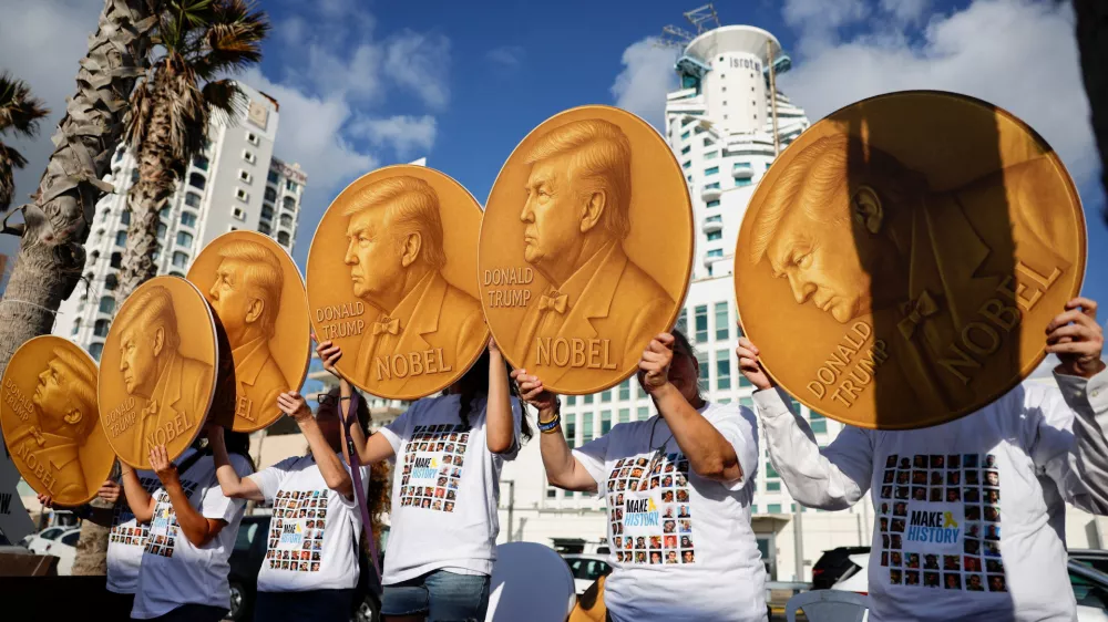 Protesters hold up signs with images depicting U.S. President Donald Trump and the words "Nobel" written on them, as supporters and family members of hostages who were kidnapped during the deadly October 7, 2023 attack on Israel by Hamas, demonstrate to demand the immediate end of the war and the release of all hostages, outside the U.S. Consulate in Tel Aviv, Israel, September 2, 2025. REUTERS/Ammar Awad  TPX IMAGES OF THE DAY