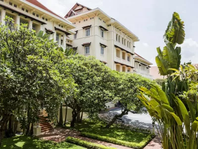 Phnom Penh's Raffles Hotel Le Royal is one of Asia's great classic hotels. Its elegant French colonial building, with cool black and white tiled floors, a dark teak staircase, high ceilings, louvered shutters and overhead fans, is an artistic statement of Khmer, Art Deco and French style. Originally opened in 1929, and re-opened in 1997, after a sympathetic extension and refurbishment by Raffles Hotels Fresh Takeo River Lobster Amok with Coconut Milk; Long Hours Braised Lamb Shanks in a Star Anise and Palm Sugar Sauce, with Stir Fried KaiLan (Chinese Broccoli) and Crispy Rice.,Image: 260087142, License: Rights-managed, Restrictions:, Model Release: no