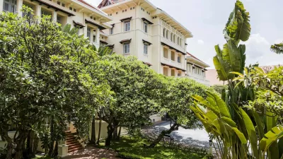 Phnom Penh's Raffles Hotel Le Royal is one of Asia's great classic hotels. Its elegant French colonial building, with cool black and white tiled floors, a dark teak staircase, high ceilings, louvered shutters and overhead fans, is an artistic statement of Khmer, Art Deco and French style. Originally opened in 1929, and re-opened in 1997, after a sympathetic extension and refurbishment by Raffles Hotels Fresh Takeo River Lobster Amok with Coconut Milk; Long Hours Braised Lamb Shanks in a Star Anise and Palm Sugar Sauce, with Stir Fried KaiLan (Chinese Broccoli) and Crispy Rice.,Image: 260087142, License: Rights-managed, Restrictions:, Model Release: no