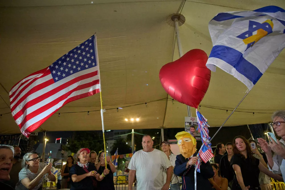 Relatives and supporters of Israeli hostages held by Hamas in the Gaza Strip celebrate after the announcement that Israel and Hamas have agreed to the first phase of a peace plan, as they gather at a plaza known as the hostages square in Tel Aviv, Israel, Thursday, Oct. 9, 2025. (AP Photo/Ohad Zwigenberg)