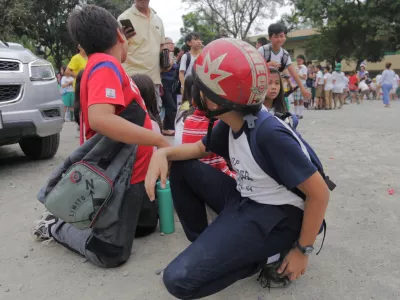Children evacuate a school after a strong earthquake in Davao City, Philippines on Friday Oct. 10, 2025. (AP Photo/Manman Dejeto)