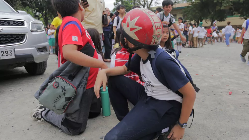 Children evacuate a school after a strong earthquake in Davao City, Philippines on Friday Oct. 10, 2025. (AP Photo/Manman Dejeto)