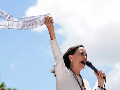 FILE - Opposition leader Maria Corina Machado holds up tally sheets during a protest against the reelection of President Nicolás Maduro one month after the disputed presidential vote which she says the opposition won by a landslide, in Caracas, Venezuela, Aug. 28, 2024. (AP Photo/Ariana Cubillos, File)