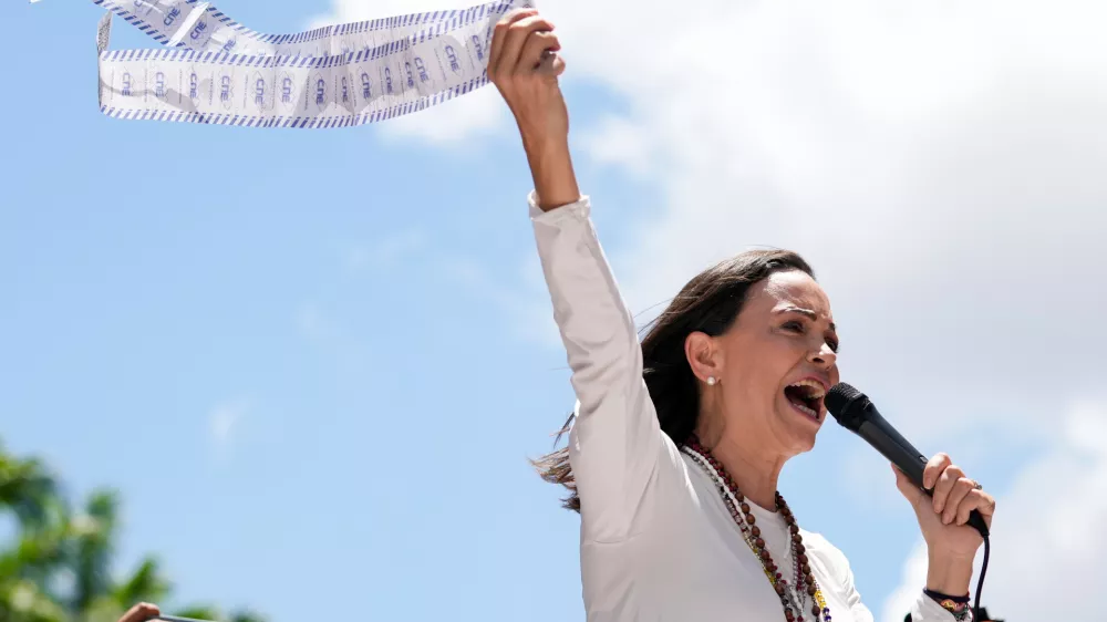 FILE - Opposition leader Maria Corina Machado holds up tally sheets during a protest against the reelection of President Nicolás Maduro one month after the disputed presidential vote which she says the opposition won by a landslide, in Caracas, Venezuela, Aug. 28, 2024. (AP Photo/Ariana Cubillos, File)