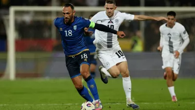 Soccer Football - FIFA World Cup - UEFA Qualifiers - Group B - Kosovo v Slovenia - Fadil Vokrri Stadium, Pristina, Kosovo - October 10, 2025 Kosovo's Vedat Muriqi in action with Slovenia's Timi Elsnik REUTERS/Valdrin Xhemaj