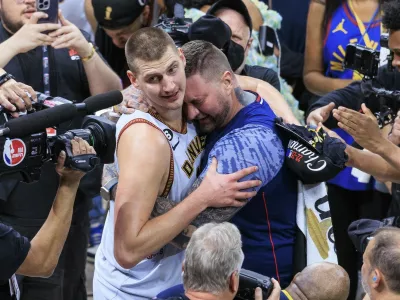 June 12, 2023, Denver, Colorado, USA: NIKOLA JOKIC #15 of the Denver Nuggets is congratulated by his brother after winning Game 5 of the 2023 NBA Finals game against the Miami Heat on Monday at Ball Arena in Denver, Colorado. Nuggets defeat Heat, 94-89.,Image: 783112254, License: Rights-managed, Restrictions:, Model Release: no, Pictured: Jokic Nikola