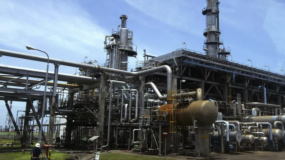A worker cycles in the Balongan refinery belonging to Indonesia's state oil firm Pertamina in Indramayu, in West Java province March 5, 2009. Asia's top diesel importer Indonesia has asked Kuwait to cut second-quarter term supplies by nearly 80 percent, as an economic downturn and increasing use of alternative fuel erode demand, industry sources said on Thursday. State-run energy firm Pertamina sought to reduce term supplies from Kuwait Petroleum Corp (KPC) to 1.2 million barrels from 5.4 million barrels, even as the Middle East producer agreed to let Indonesia resell some committed volumes, they said. REUTERS/Dadang Tri (INDONESIA)