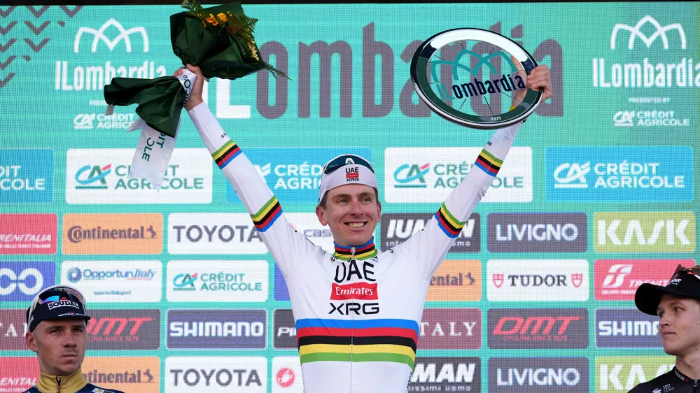 Reigning World Champion Tadej Pogacar of Slovenia, center, winner of Il Lombardia, Tour of Lombardy cycling race, celebrates on podium with second placed Belgium's Remco Evenepoel, left, and third placed Australia's Michael Storer, in Bergamo, Italy, Saturday, Oct. 11, 2025. (Gian Mattia D'Alberto /LaPresse via AP)