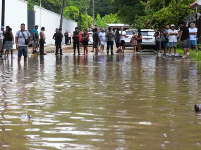 People look at a flooded street after torrential rains that caused an overflow of rivers in Poza Rica, Veracruz state, Mexico, October 10, 2025. REUTERS/Rolando Ramos